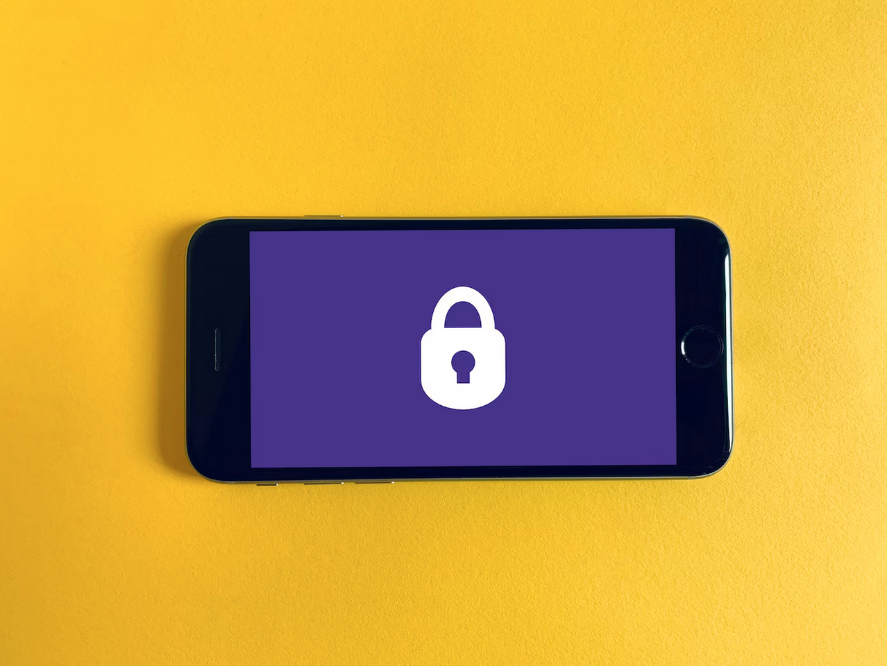 a iPhone in landscape view displaying an image of a white lock icon on a purple background